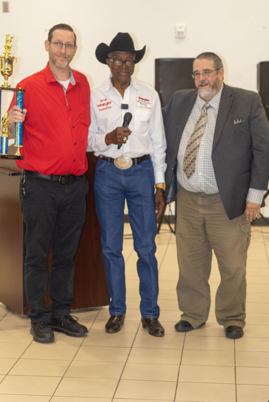 Harold Cash holding a microphone at the awards banquet