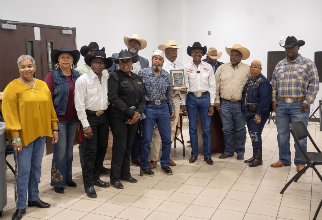 Charity members in cowboy hats at the awards banquet